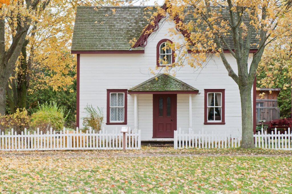 white and red wooden house with fence 1029599.jpeg